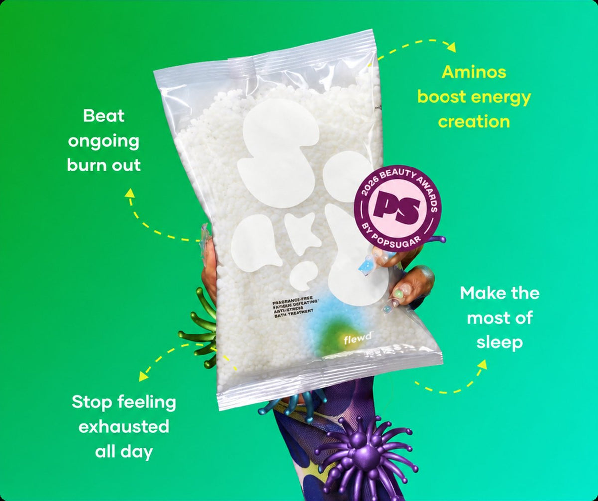 Flewd fragrance-free Fatigue Defeating bath soak clear pouch held up on a green background, for tired, drained days