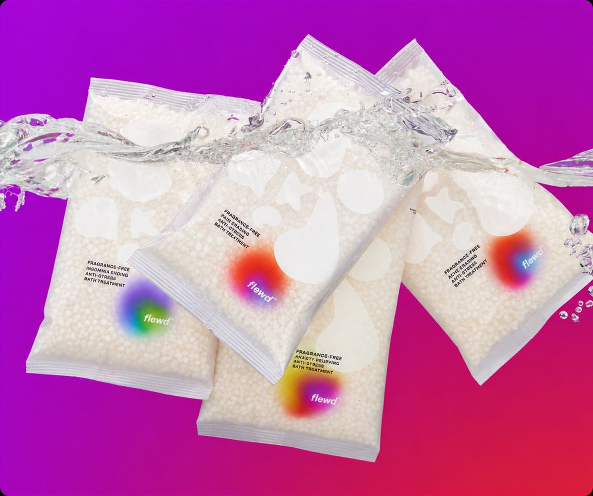 Four fragrance-free Whole Mood Bundle magnesium bath soak pouches with a water splash