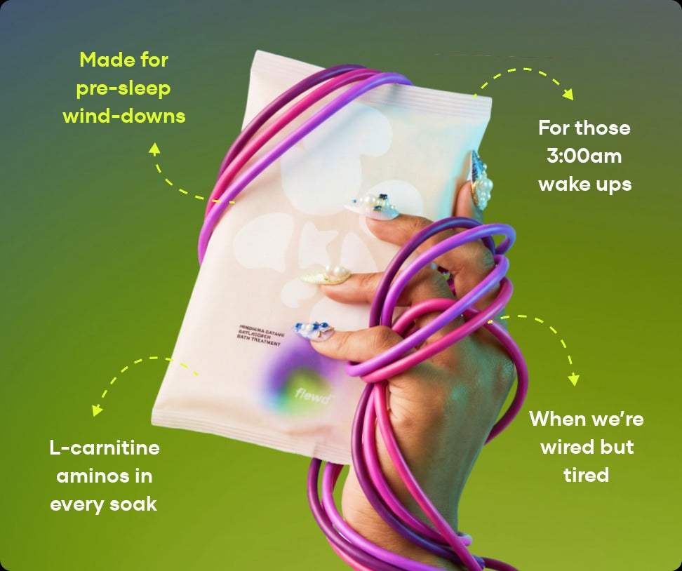 Flewd Insomnia Ending bath soak pouch held in a hand wrapped in purple cables, for sleepless nights