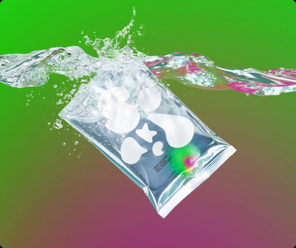 Flewd Panic Crushing magnesium bath soak pouch splashing into water on a green background
